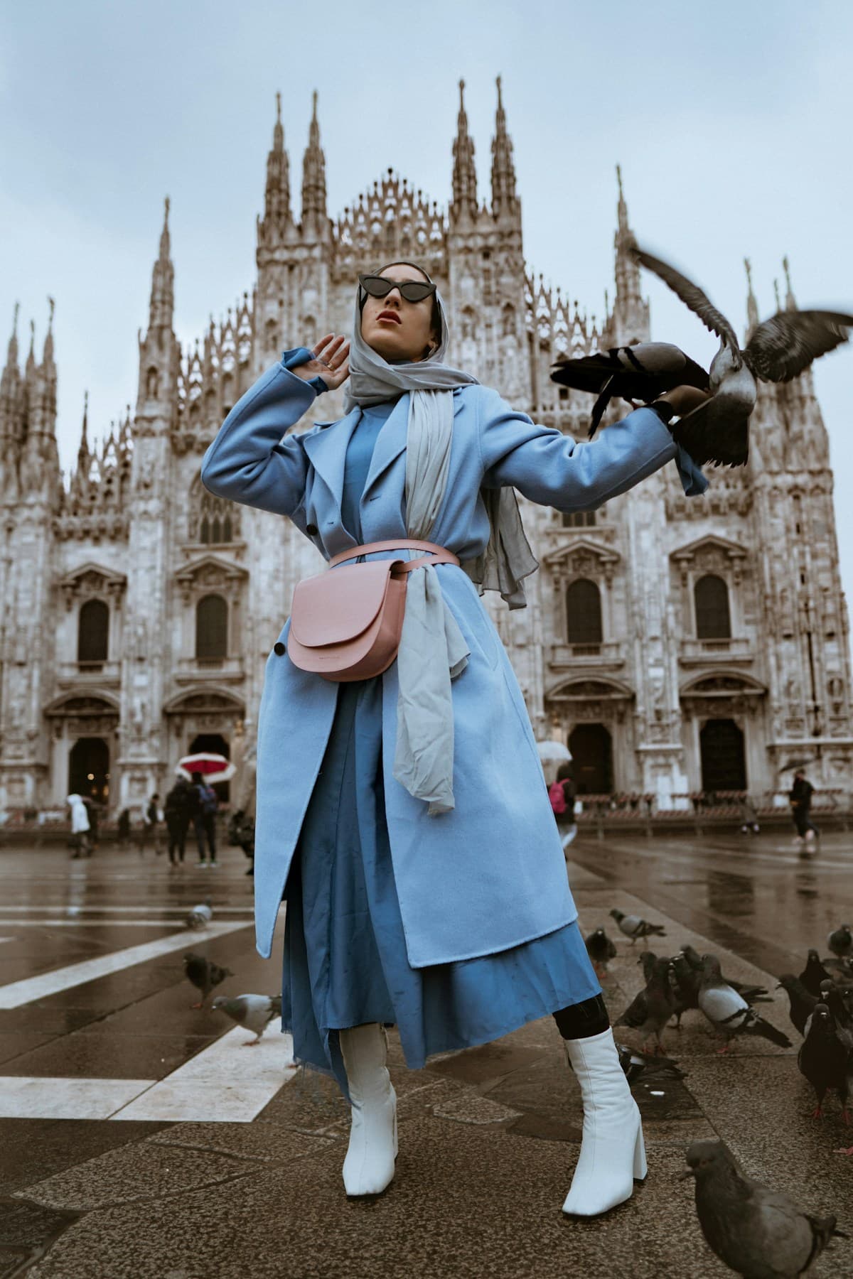 Fashion editorial featuring a blue coat and pink handbag
